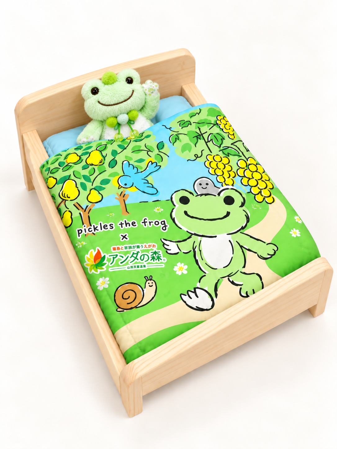 小さなピクルスのぬいぐるみが専用ベッドに入るイメージ